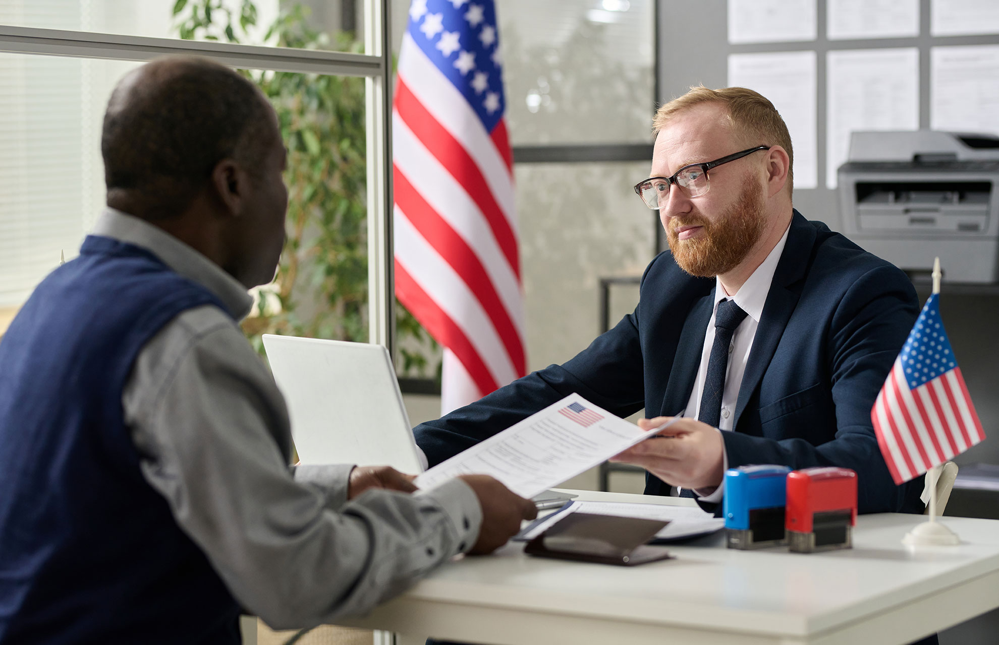 worker-handing-visa-application-to-man-Q3HUU2M.jpg